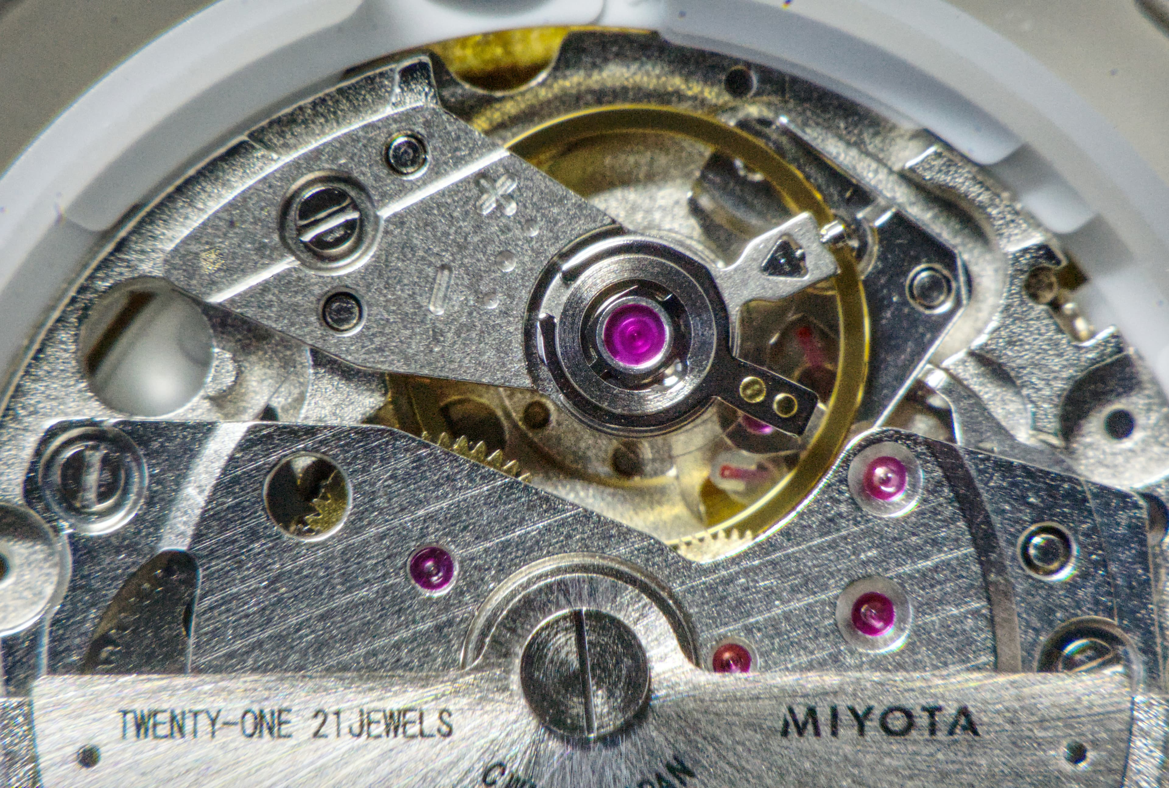 Miyota 21-jewel automatic movement visible through an opened screw-down case back
